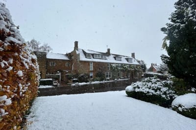 Exterior view of Wardington Court covered in snow.