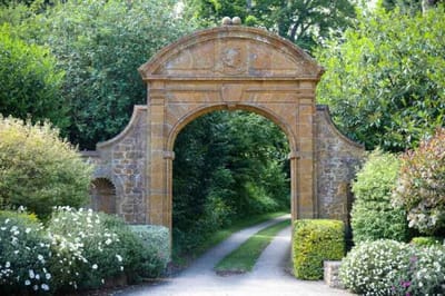 Pathway leading through a garden archway