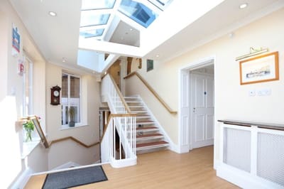 Bright interior hallway with skylights and decor.