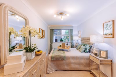 Cozy private bedroom with elegant decor and plants.