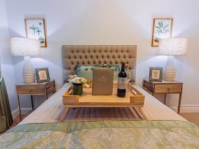 Well-decorated bedroom with a wine bottle and flowers
