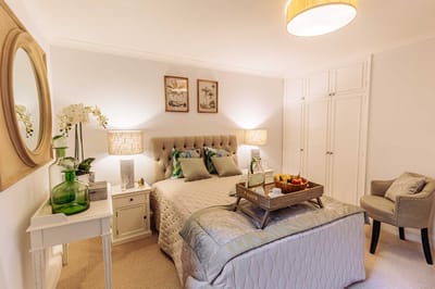 Cozy bedroom with a tray of fruit and decor.