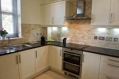 Modern kitchen with light-colored cabinets and countertops.