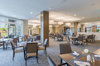 Bright dining area with tables and chairs.