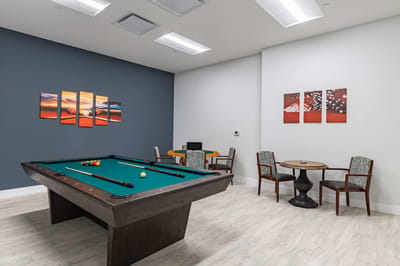 Interior game area with pool table and seating