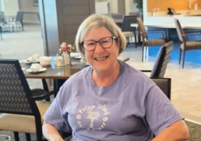 Smiling resident in common dining area
