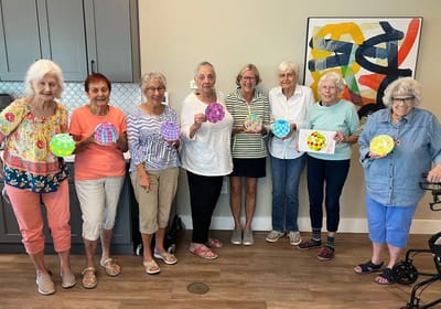 Residents participating in an art activity indoors.