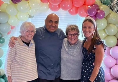 Residents and staff celebrating at a festive event