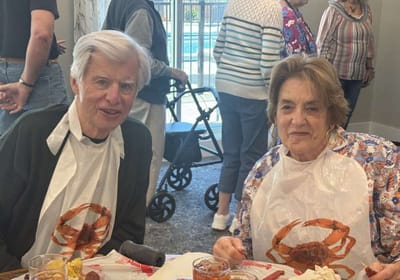 Two residents enjoying a crab dinner together.