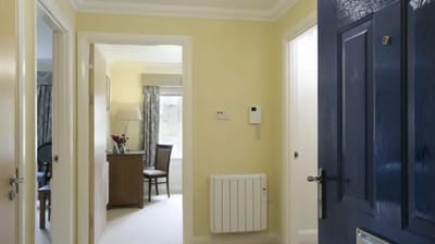 Interior hallway with light-colored walls and furniture