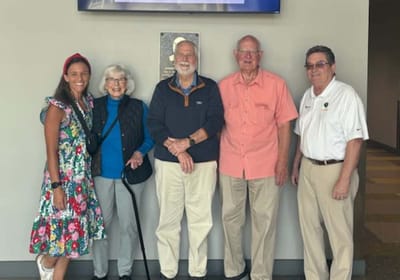 Residents and staff posing together in a common area.
