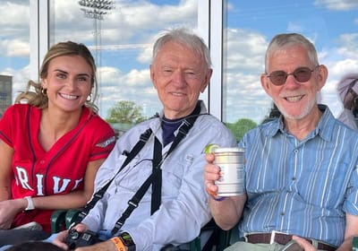 Three individuals enjoying time outdoors at an event.