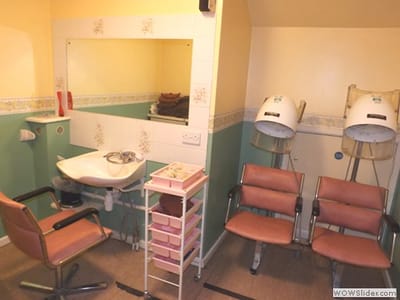Hair salon area with shampoo basin and chairs
