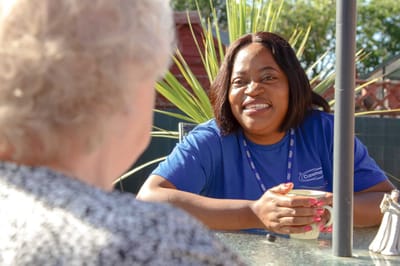 Staff member engaging with a resident outdoors.