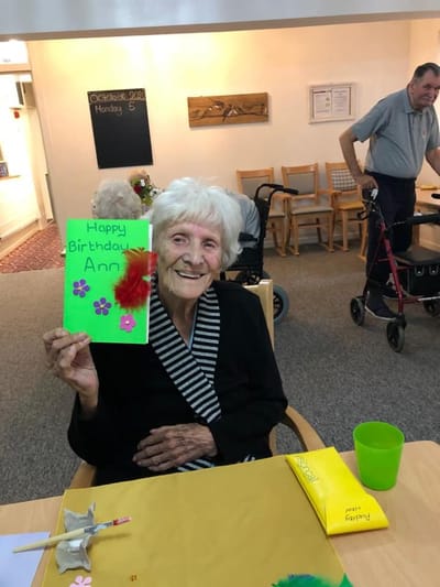 Resident celebrating with a birthday card