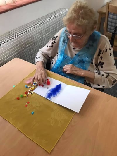 Senior resident engaging in a creative activity.
