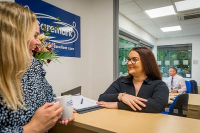 Two staff members interacting at reception