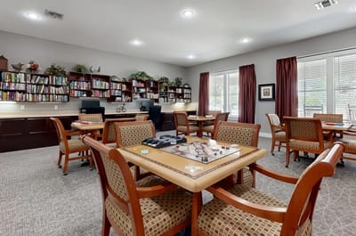 Common area with tables and bookshelves.