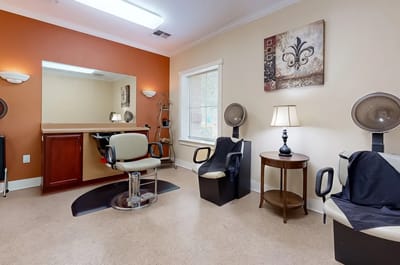 Hair salon area with styling chairs and mirrors.