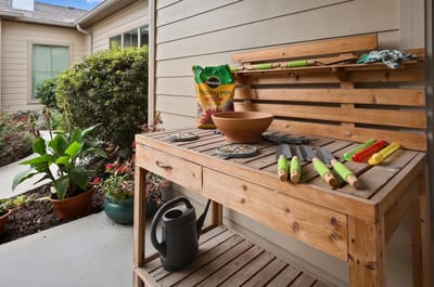 Gardening station with tools and pots in an outdoor area.