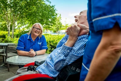 Staff and resident enjoying time outdoors.