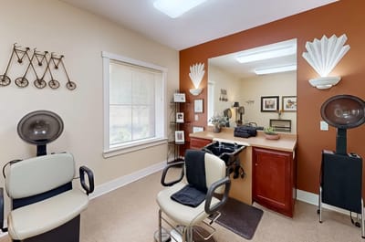 Hair salon area with styling chairs and mirrors.
