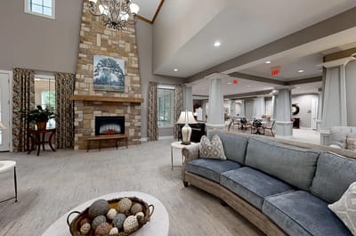 Bright common area with cozy seating and fireplace