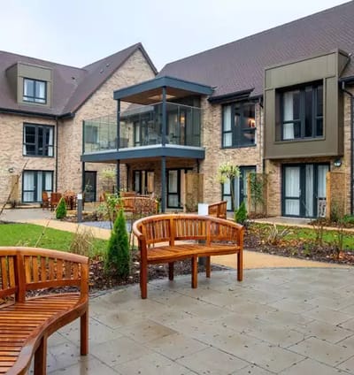 Exterior view of Cambridge Grove with seating area.