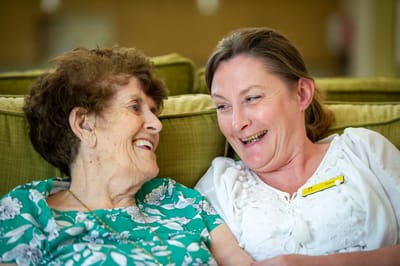 Staff member and resident sharing a joyful moment