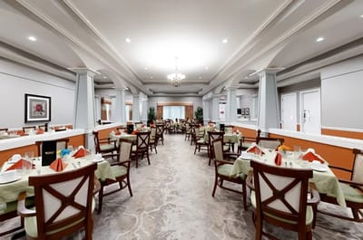 Dining room setup with tables and chairs.