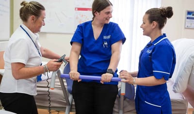 Staff assisting each other in a care setting