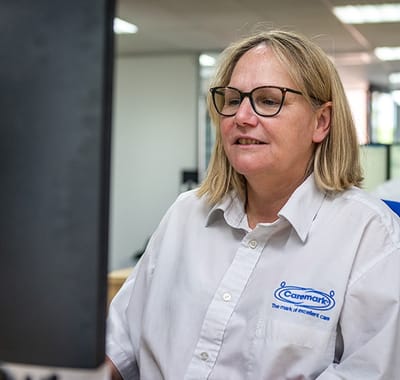 Staff member working at a computer station.