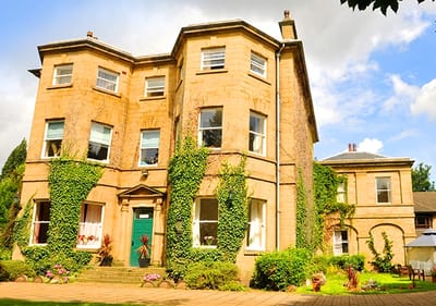 Historic building exterior surrounded by greenery.
