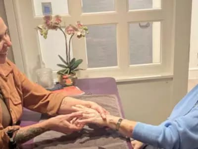 Staff providing hand massage to a resident
