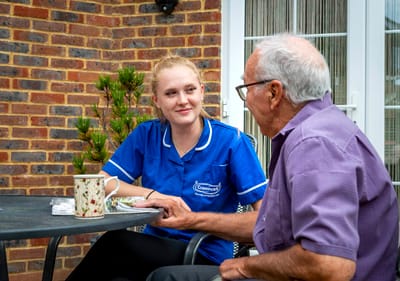 Staff member engaging with resident outdoors