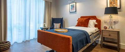 Cozy resident room with bed and decor.