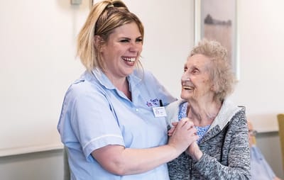 Staff member joyfully interacting with resident