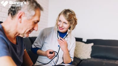 Caregiver measuring a patient's blood pressure.