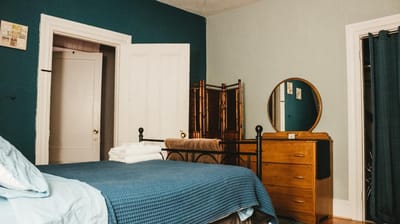 Cozy interior bedroom with a bed and dresser