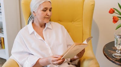 Senior woman reading in a cozy chair