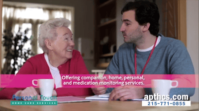 A caregiver and resident in a warm conversation.