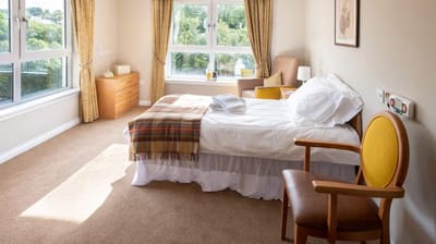 Comfortable bedroom with natural light and view