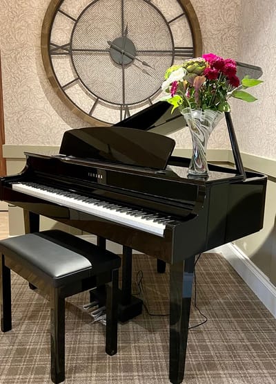 Grand piano with flowers in a lounge area