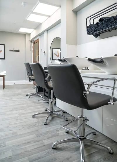 Beauty salon area with styling chairs and equipment