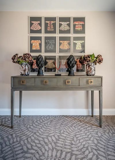 Decorative console table with framed art pieces