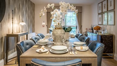 Elegant dining setup with tableware and flowers