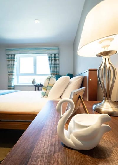Cozy bedroom with decorative swan and lamp