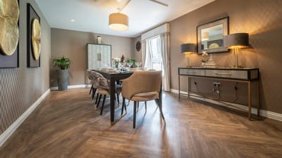 Elegant dining room setup with table and chairs.
