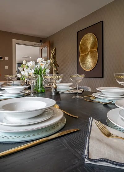 Elegant dining table set with flowers and glassware.