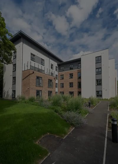 Exterior view of a residential building with greenery